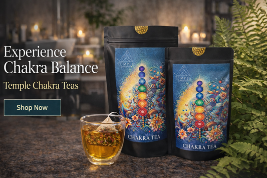 Two packages of Temple Chakra Teas with a glass of tea on a dark surface.