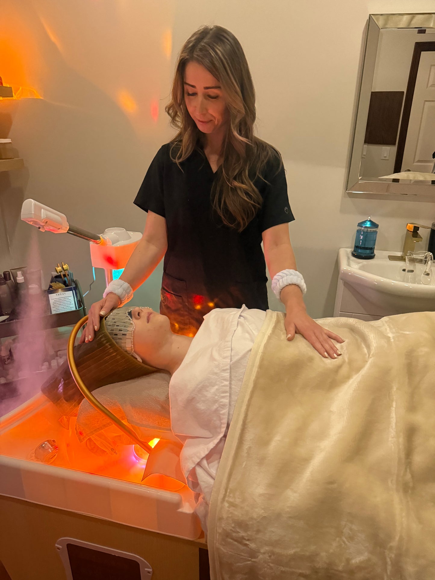 Woman receiving a Japanese head spa   in a spa setting with warm lighting.